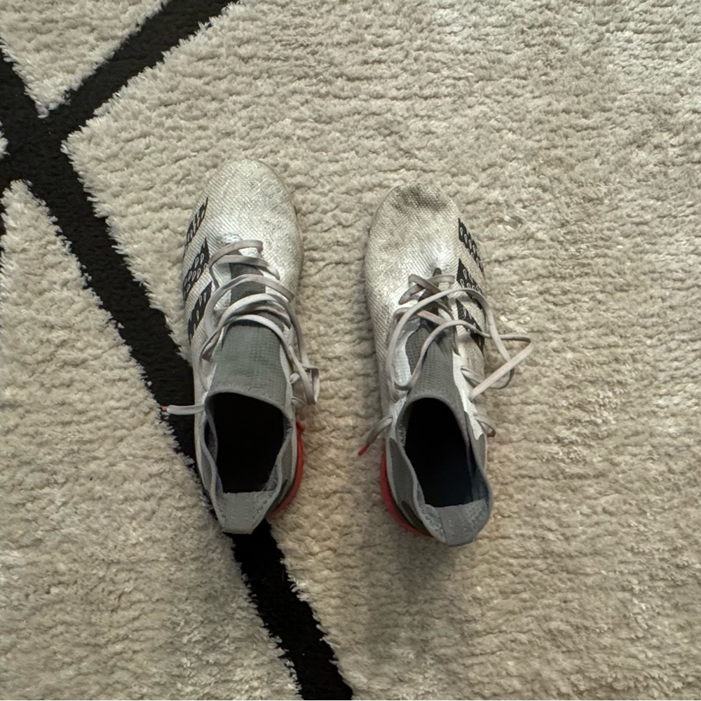 Adidas White and Gray Soccer Cleats with Red Soles